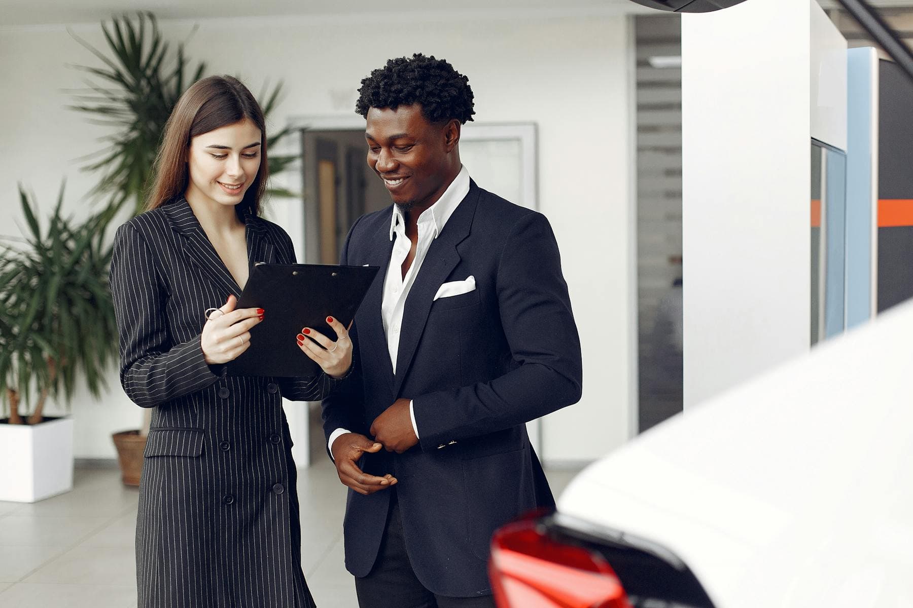 Dealership manager reviewing access rules, policy folders, and team documents on a laptop.